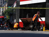 TTC workers are fixing a streetcar as it is stuck at King Street East and Church Street in Toronto, Canada, on June 19, 2024. (