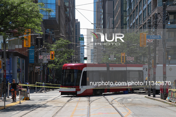 TTC workers are fixing a streetcar as it is stuck at King Street East and Church Street in Toronto, Canada, on June 19, 2024. 