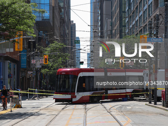 TTC workers are fixing a streetcar as it is stuck at King Street East and Church Street in Toronto, Canada, on June 19, 2024. (