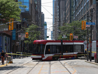 TTC workers are fixing a streetcar as it is stuck at King Street East and Church Street in Toronto, Canada, on June 19, 2024. (