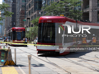 TTC workers are fixing a streetcar as it is stuck at King Street East and Church Street in Toronto, Canada, on June 19, 2024. (