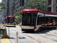 TTC workers are fixing a streetcar as it is stuck at King Street East and Church Street in Toronto, Canada, on June 19, 2024. (