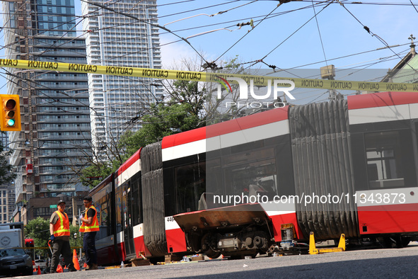 TTC workers are fixing a streetcar as it is stuck at King Street East and Church Street in Toronto, Canada, on June 19, 2024. 