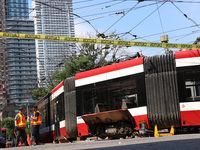 TTC workers are fixing a streetcar as it is stuck at King Street East and Church Street in Toronto, Canada, on June 19, 2024. (