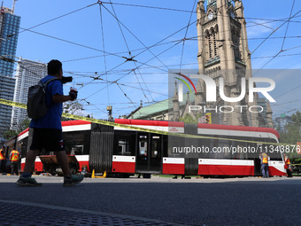 TTC workers are fixing a streetcar as it is stuck at King Street East and Church Street in Toronto, Canada, on June 19, 2024. (