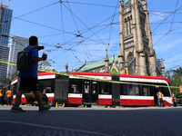 TTC workers are fixing a streetcar as it is stuck at King Street East and Church Street in Toronto, Canada, on June 19, 2024. (