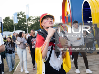 German football fans are celebrating after the Germany vs. Hungary match ahead of UEFA EURO 2024 at a fan base near the Brandenburg Gate in...