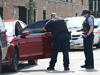 A vehicle is being investigated at the crime scene. A 22-year-old male is being shot multiple times in Chicago, Illinois, United States, on...