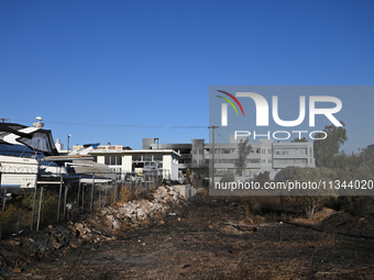 Industrial property is being damaged by a wildfire breaking out in Koropi near Athens, Greece, on June 19, 2024. (