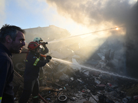 Firefighters are dropping water to extinguish a fire inside a container in Koropi near Athens, Greece, on June 19, 2024. (