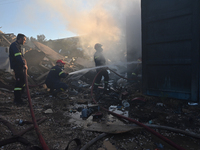 Firefighters are dropping water to extinguish a fire inside a container in Koropi near Athens, Greece, on June 19, 2024. (