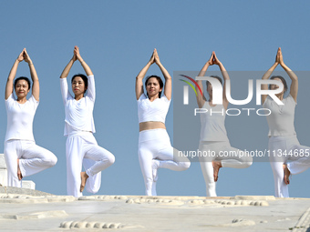 Yoga lovers are practicing yoga at Fengfeng Health Theme Cultural Park in Handan, China, on June 20, 2024. (