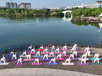 Yoga lovers are practicing yoga at Fengfeng Health Theme Cultural Park in Handan, China, on June 20, 2024. (