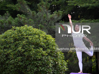 Yoga lovers are practicing yoga at Fengfeng Health Theme Cultural Park in Handan, China, on June 20, 2024. (