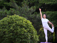 Yoga lovers are practicing yoga at Fengfeng Health Theme Cultural Park in Handan, China, on June 20, 2024. (