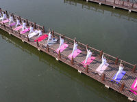 Yoga lovers are practicing yoga at Fengfeng Health Theme Cultural Park in Handan, China, on June 20, 2024. (