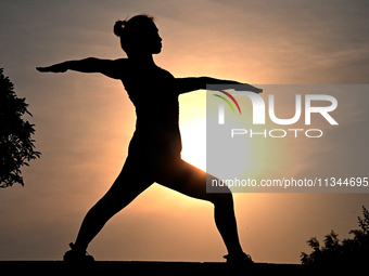 Yoga lovers are practicing yoga at Fengfeng Health Theme Cultural Park in Handan, China, on June 20, 2024. (