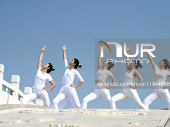 Yoga lovers are practicing yoga at Fengfeng Health Theme Cultural Park in Handan, China, on June 20, 2024. (