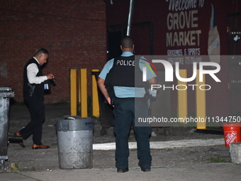 Police officers are investigating at the crime scene. One person is killed and another is injured in a shooting in Chicago, Illinois, United...