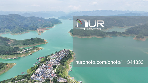 An aerial photo is showing the ecological scenery of Wanfeng Lake in Xingyi, China, on June 20, 2024. 