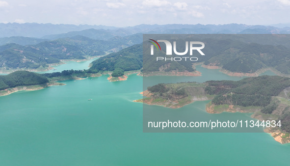 An aerial photo is showing the ecological scenery of Wanfeng Lake in Xingyi, China, on June 20, 2024. 