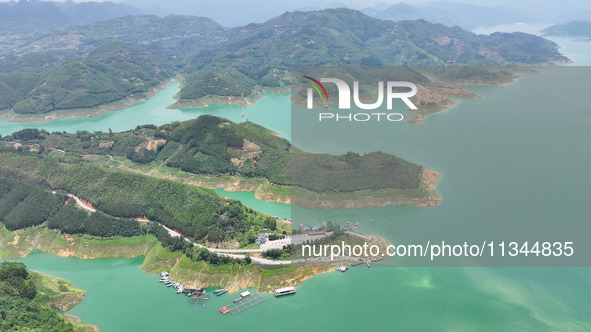 An aerial photo is showing the ecological scenery of Wanfeng Lake in Xingyi, China, on June 20, 2024. 