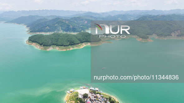 An aerial photo is showing the ecological scenery of Wanfeng Lake in Xingyi, China, on June 20, 2024. 