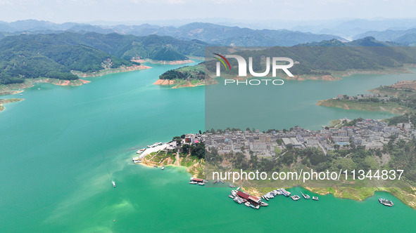 An aerial photo is showing the ecological scenery of Wanfeng Lake in Xingyi, China, on June 20, 2024. 