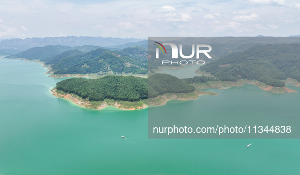 An aerial photo is showing the ecological scenery of Wanfeng Lake in Xingyi, China, on June 20, 2024. 