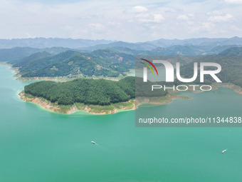 An aerial photo is showing the ecological scenery of Wanfeng Lake in Xingyi, China, on June 20, 2024. (