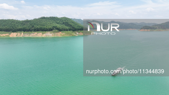 An aerial photo is showing the ecological scenery of Wanfeng Lake in Xingyi, China, on June 20, 2024. 