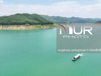 An aerial photo is showing the ecological scenery of Wanfeng Lake in Xingyi, China, on June 20, 2024. (