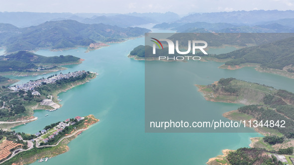 An aerial photo is showing the ecological scenery of Wanfeng Lake in Xingyi, China, on June 20, 2024. 