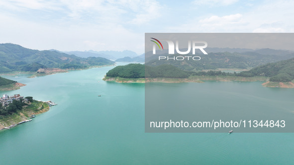 An aerial photo is showing the ecological scenery of Wanfeng Lake in Xingyi, China, on June 20, 2024. 