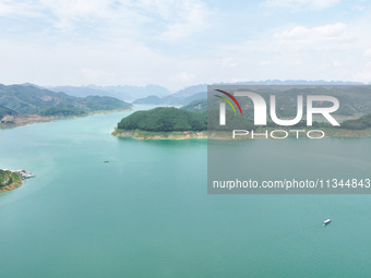 An aerial photo is showing the ecological scenery of Wanfeng Lake in Xingyi, China, on June 20, 2024. (