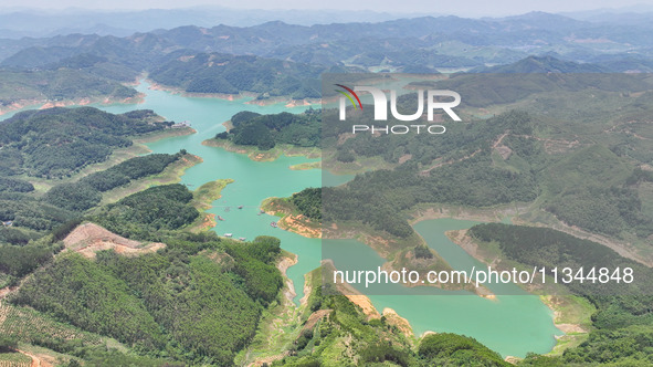 An aerial photo is showing the ecological scenery of Wanfeng Lake in Xingyi, China, on June 20, 2024. 