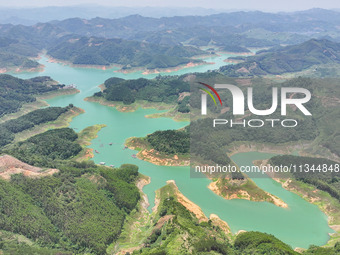 An aerial photo is showing the ecological scenery of Wanfeng Lake in Xingyi, China, on June 20, 2024. (