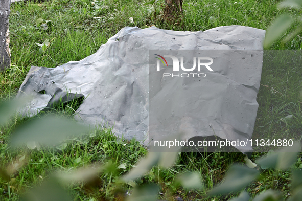 A piece of metal is lying on the grass outside an administrative building of the State Research Control Institute of Veterinary Medicinal Pr...