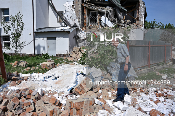 A man is standing among the rubble at the State Research Control Institute of Veterinary Medicinal Products and Feed Additives after a night...