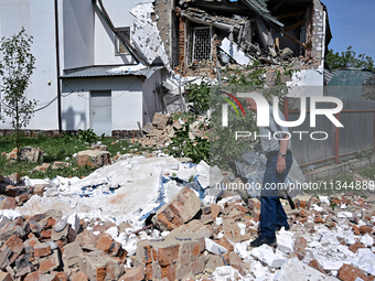 A man is standing among the rubble at the State Research Control Institute of Veterinary Medicinal Products and Feed Additives after a night...