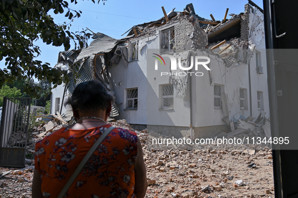 A woman is facing an administrative building of the State Research Control Institute of Veterinary Medicinal Products and Feed Additives dam...