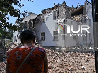 A woman is facing an administrative building of the State Research Control Institute of Veterinary Medicinal Products and Feed Additives dam...