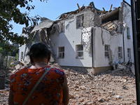 A woman is facing an administrative building of the State Research Control Institute of Veterinary Medicinal Products and Feed Additives dam...