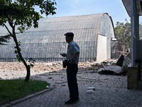 A man is looking at damage done by a nighttime Russian kamikaze drone attack to the State Research Control Institute of Veterinary Medicinal...