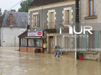 A man is standing in front of his bakery after rising waters in Narcy, France, on June 20, 2024. (