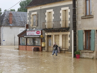 A man is standing in front of his bakery after rising waters in Narcy, France, on June 20, 2024. (