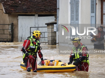 Firefighters are rescuing people after a huge storm in Narcy, France, on June 20, 2024. (