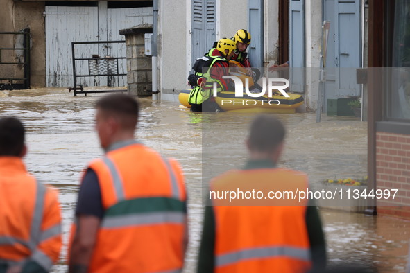 Firefighters are rescuing people after a huge storm in Narcy, France, on June 20, 2024. 