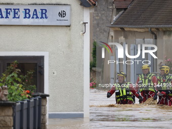 Firefighters are rescuing people after a huge storm in Narcy, France, on June 20, 2024. (