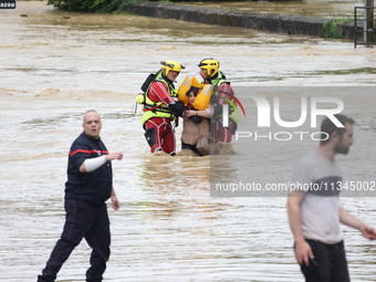 Firefighters are rescuing people after a huge storm in Narcy, France, on June 20, 2024. (